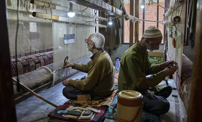 Kashmiri artisans weave hand-knotted carpets at a factory in Srinagar, Indian controlled Kashmir, on April 14, 2025. (AP Photo/Dar Yasin)