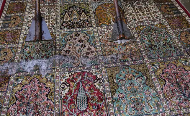 Kashmiri workers wash hand-knotted carpets at a workshop in Srinagar, Indian controlled Kashmir, on April 12, 2025. (AP Photo/Dar Yasin)