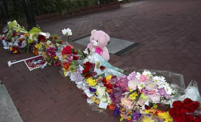 An impromptu memorial of flowers and other items laid near the center of the Florida State campus in sight of the Student Union building, Tallahassee, Fla., Thursday, April 17, 2025. (AP Photo/Gary McCullough)