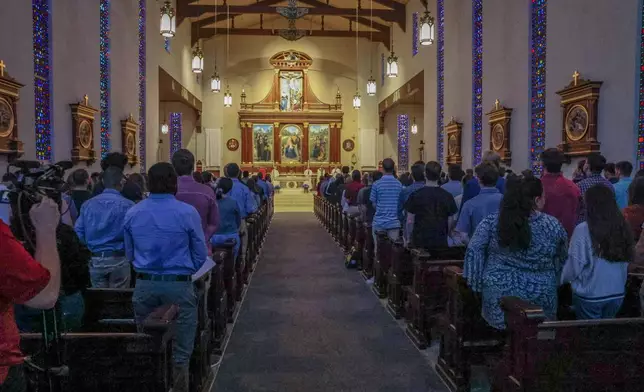 A service is held at Co-Cathedral of St. Thomas More, a Catholic cathedral, across from the Woodward Avenue entrance to Florida State University campus, following a shooting, Thursday, April 17, 2025, in Tallahassee, Fla. (AP Photo/Gary McCullough)