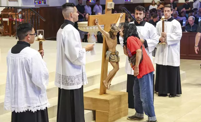 On Good Friday, at the Co-Cathedral of St. Thomas More, Catholics observe a special rite called the Adoration of the Cross, where they venerate the cross, a symbol of Christ's sacrifice and the source of salvation, Tallahassee, Fla., Friday, April 18, 2025. (AP Photo/Gary McCullough)