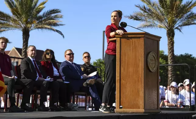 The day after an active shooter on campus Florida State Dr. Amy Hecht vice president of student affairs addresses a vigil on campus at Langford Green, Tallahassee, Fla., Friday, April 18, 2025. (AP Photo/Gary McCullough)