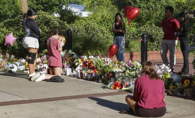 Students gather on a stretch of sidewalk near the center of the Florida State campus in sight of the Student Union building, Tallahassee, Fla., Friday, April 18, 2025. (AP Photo/Gary McCullough)