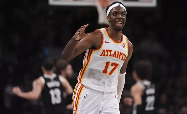 Atlanta Hawks' Onyeka Okongwu (17) gestures after making a three-point shot during the second half of an NBA basketball game against the Brooklyn Nets Thursday, April 10, 2025, in New York. (AP Photo/Frank Franklin II)