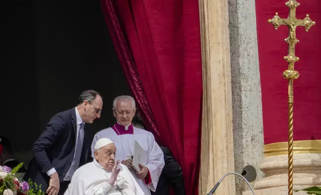 Pope Francis appears on the central lodge of St. Peter's Basilica to bestow the Urbi et Orbi (Latin for to the city and the world) blessing at the end of the Easter mass presided over by Cardinal Angelo Comastri in St. Peter's Square at the Vatican Sunday, April 20, 2025. (AP Photo/Gregorio Borgia)