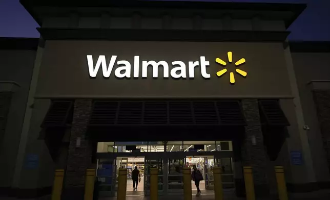 Shoppers enter a Walmart store in La Habra, Calif., Wednesday, April 9, 2025. (AP Photo/Jae C. Hong)