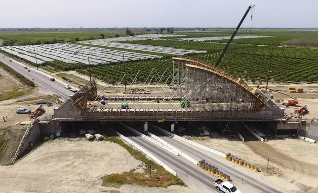 The Tied Arch Bridge construction site, which will take high-speed trains over State Route 43, is shown in an aerial view Tuesday, April 15, 2025, in Fresno County, Calif. (AP Photo/Godofredo A. Vásquez)