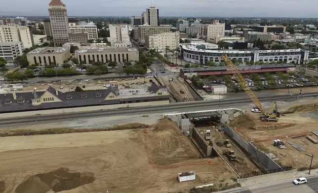 California High-Speed Rail Authority crews work at a construction site in downtown Fresno, Calif., Tuesday, April 15, 2025. (AP Photo/Godofredo A. Vásquez)