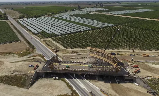 The Tied Arch Bridge construction site, which will take high-speed trains over State Route 43, is shown in an aerial view, Tuesday, April 15, 2025, in Fresno County, Calif. (AP Photo/Godofredo A. Vásquez)