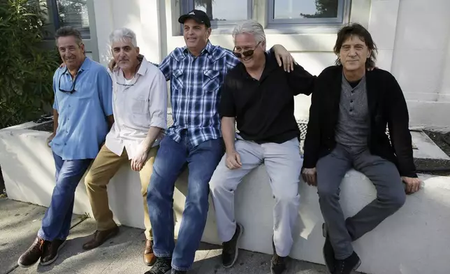 FILE - In this Friday, April 13, 2018, photo, the Waldos, from left, Mark Gravitch, Larry Schwartz, Dave Reddix, Jeffrey Noel and Steve Capper sit on a wall they used to frequent at San Rafael High School in San Rafael, Calif. Friday is April 20, or 4/20. (AP Photo/Eric Risberg, File)