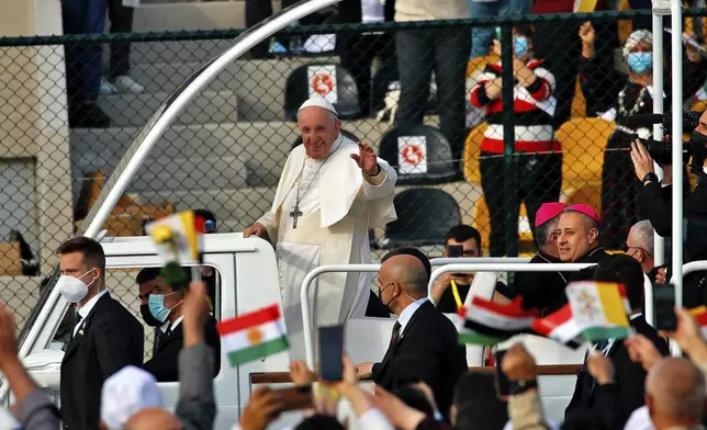 FILE - Pope Francis waves as he arrives for an open air Mass at a stadium in Irbil, Iraq, March 7, 2021. (AP Photo/Hadi Mizban, file)