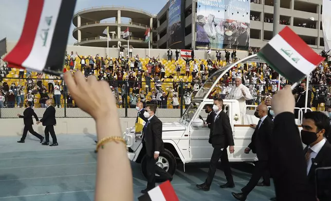 FILE.- Pope Francis waves as he arrives for an open air Mass at a stadium in Irbil, Iraq, Sunday, March 7, 2021. (AP Photo/Hadi Mizban,File)