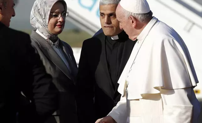 FILE - Pope Francis is welcomed as he arrives at Irbil airport, Iraq, March 7, 2021. (AP Photo/Hadi Mizban, file)