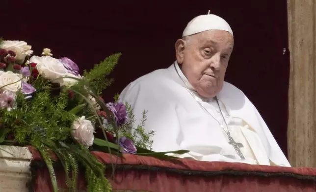 Pope Francis appears on the central lodge of St. Peter's Basilica to bestow the Urbi et Orbi (Latin for to the city and the world) blessing at the end of the Easter mass presided over by Cardinal Angelo Comastri in St. Peter's Square at the Vatican Sunday, April 20, 2025. (AP Photo/Gregorio Borgia)
