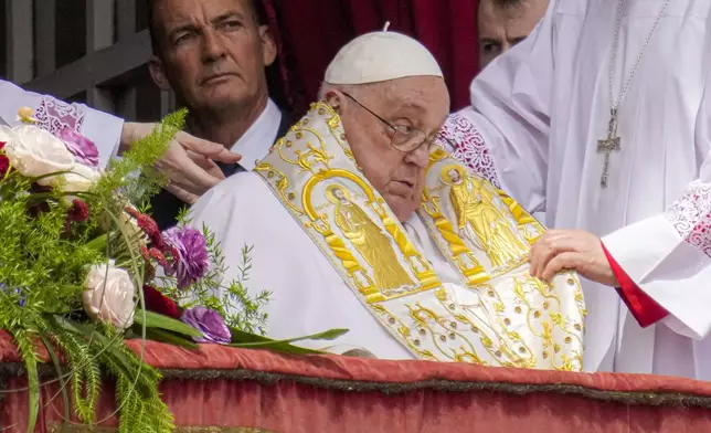 Pope Francis appears on the central lodge of St. Peter's Basilica to bestow the Urbi et Orbi (Latin for to the city and to the world) blessing at the end of the Easter mass presided over by Cardinal Angelo Comastri in St. Peter's Square at the Vatican Sunday, April 20, 2025.(AP Photo/Gregorio Borgia)