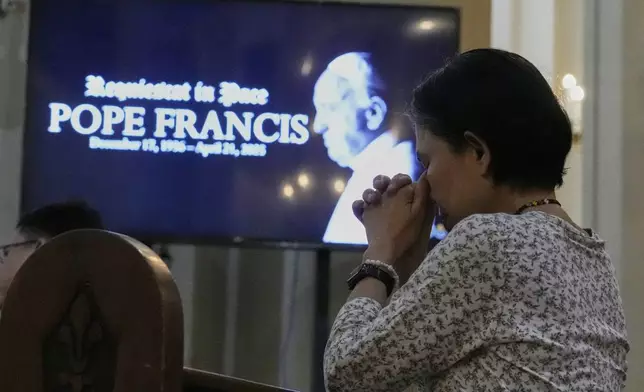 A devotee prays during a mass for the late Pope Francis at the Cubao Cathedral in Quezon city, Philippines Monday, April 21, 2025. (AP Photo/Aaron Favila)