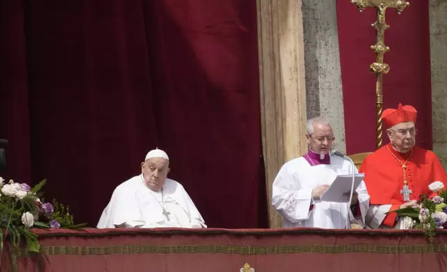 Pope Francis, left, appears on the central lodge of St. Peter's Basilica to bestow the Urbi et Orbi (Latin for to the city and to the world) blessing at the end of the Easter mass presided over by Cardinal Angelo Comastri in St. Peter's Square at the Vatican Sunday, April 20, 2025. (AP Photo/Gregorio Borgia)