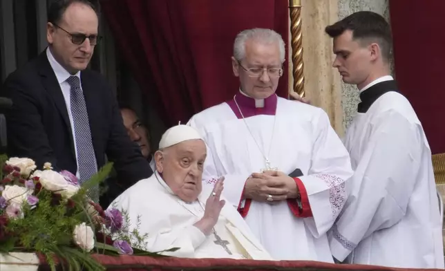 Pope Francis appears on the central lodge of St. Peter's Basilica to bestow the Urbi et Orbi (Latin for to the city and to the world) blessing at the end of the Easter mass presided over by Cardinal Angelo Comastri in St. Peter's Square at the Vatican Sunday, April 20, 2025.(AP Photo/Gregorio Borgia)