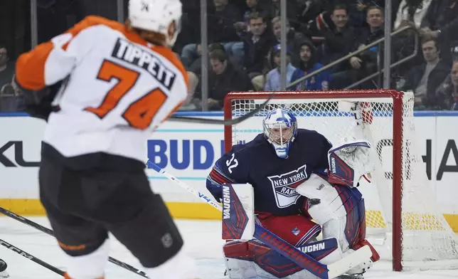 New York Rangers goaltender Jonathan Quick (32) stops a shot by Philadelphia Flyers' Owen Tippett (74) during the second period of an NHL hockey game Wednesday, April 9, 2025, in New York. (AP Photo/Frank Franklin II)