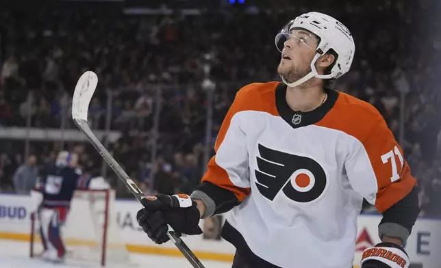 Philadelphia Flyers' Tyson Foerster (71) looks at the scoreboard after scoring a goal as he skates past New York Rangers goaltender Jonathan Quick during the second period of an NHL hockey game Wednesday, April 9, 2025, in New York. (AP Photo/Frank Franklin II)