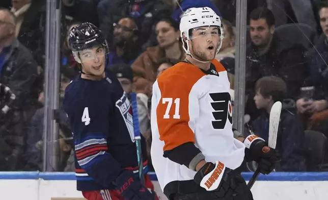 New York Rangers' Braden Schneider (4) reacts as Philadelphia Flyers' Tyson Foerster (71) celebrates after scoring a goal during the second period of an NHL hockey game Wednesday, April 9, 2025, in New York. (AP Photo/Frank Franklin II)