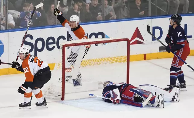 New York Rangers goaltender Jonathan Quick (32) and Artemi Panarin (10) react as Philadelphia Flyers' Jakob Pelletier (22) and Emil Andrae (36) celebrate a goal by Pelletier during the third period of an NHL hockey game Wednesday, April 9, 2025, in New York. (AP Photo/Frank Franklin II)