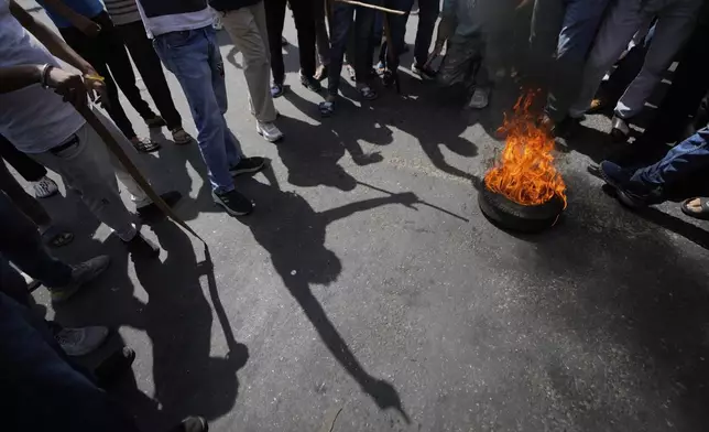 Activists of Rashtriya Bajrang Dal burn tiers shout slogans against Pakistan during protest against the Pahalgam terror attack in Jammu, India, Wednesday, April 23, 2025.(AP Photo/Channi Anand)
