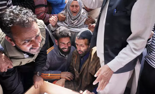 The father of Adil Hussain Shah, center right, wails next to his son's body, who was killed when militants indiscriminately opened fire on a crowd of mainly tourists on Tuesday, at his village Hapatnar, about 20 km (13 miles) from Pahalgam where the incident took place, Indian controlled Kashmir, Wednesday, April 23, 2025. (AP Photo/Dar Yasin)