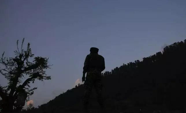 An Indian security officer stands guard in south Kashmir after assailants indiscriminately opened fired at tourists in Pahalgam, Indian controlled Kashmir, Tuesday, April 22, 2025. (AP Photo/Dar Yasin)