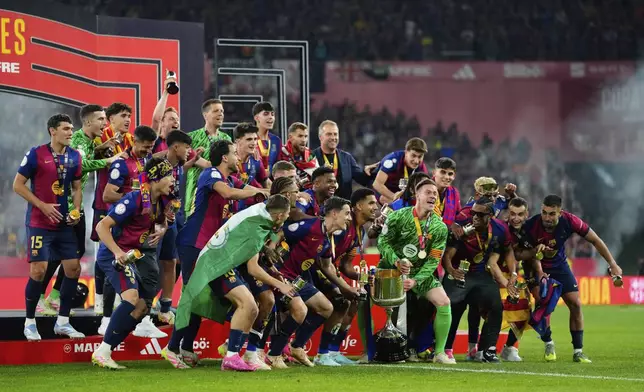 Barcelona players celebrate their victory at the Spanish Copa del Rey final soccer match between Barcelona and Real Madrid at Estadio de La Cartuja stadium in Seville, Spain, Saturday, April 26, 2025. (AP Photo/Jose Breton)