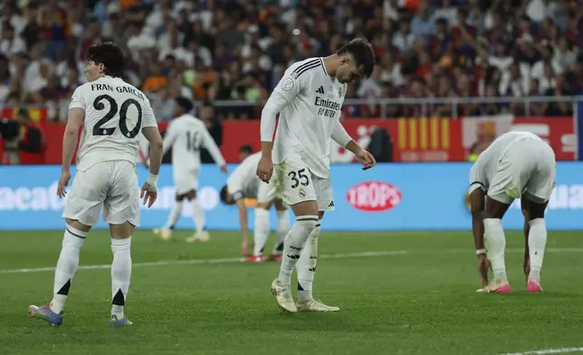 Real Madrid player react after Barcelona's Jules Kounde, scores his side's third goal during the Spanish Copa del Rey final soccer match between Barcelona and Real Madrid at Estadio de La Cartuja stadium in Seville, Spain, Sunday, April 27, 2025. (AP Photo/Joan Monfort)