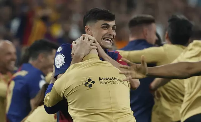Barcelona's Pedri celebrates winning the Spanish Copa del Rey final soccer match between Barcelona and Real Madrid at Estadio de La Cartuja stadium in Seville, Spain, Sunday, April 27, 2025. (AP Photo/Joan Monfort)