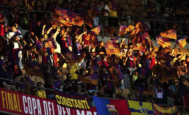 Barcelona fans cheer ahead of the Spanish Copa del Rey final soccer match between Barcelona and Real Madrid at Estadio de La Cartuja stadium in Seville, Spain, Saturday, April 26, 2025. (AP Photo/Jose Breton)