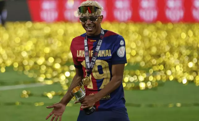 Barcelona's Lamine Yamal celebrates after winning the Spanish Copa del Rey final soccer match between Barcelona and Real Madrid at Estadio de La Cartuja stadium in Seville, Spain, Sunday, April 27, 2025. (AP Photo/Joan Monfort)
