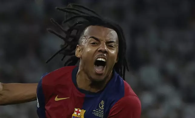 Barcelona's Jules Kounde celebrates after scoring his side's third goal during the Spanish Copa del Rey final soccer match between Barcelona and Real Madrid at Estadio de La Cartuja stadium in Seville, Spain, Sunday, April 27, 2025. (AP Photo/Joan Monfort)