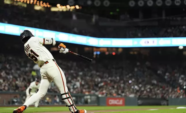 San Francisco Giants' Jung Hoo Lee hits an RBI triple during the seventh inning of a baseball game against the Milwaukee Brewers, Monday, April 21, 2025, in San Francisco. (AP Photo/Godofredo A. Vásquez)
