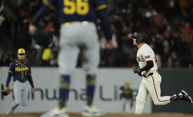 San Francisco Giants' Wilmer Flores, right, runs the bases after hitting a solo home run against Milwaukee Brewers pitcher Grant Anderson (56) during the sixth inning of a baseball game Monday, April 21, 2025, in San Francisco. (AP Photo/Godofredo A. Vásquez)