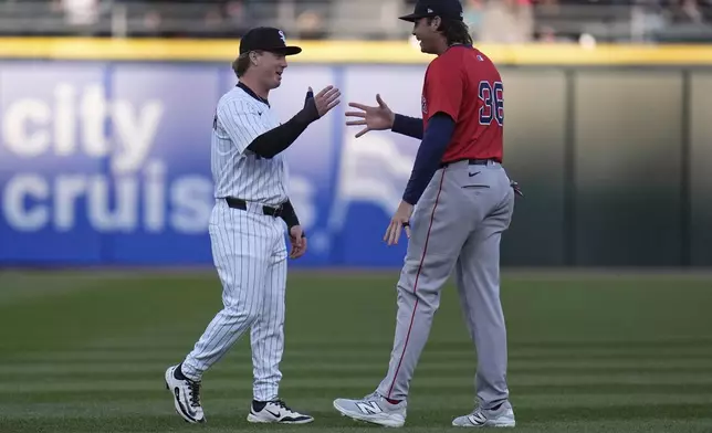 Chicago White Sox's Chase Meidroth, left, and Boston Red Sox's Triston Casas (36) greet each other before a baseball game Friday, April 11, 2025, in Chicago. (AP Photo/Erin Hooley)