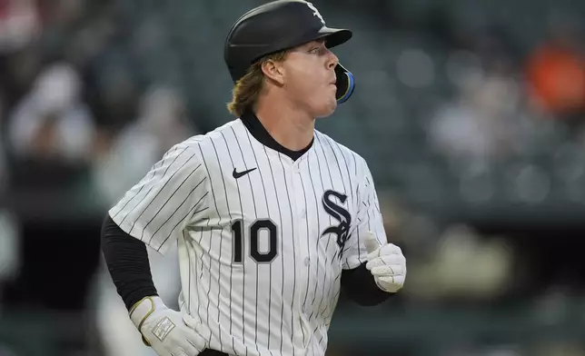 Chicago White Sox's Chase Meidroth (10) is walked by Boston Red Sox starting pitcher Sean Newcomb (19) during the second inning of a baseball game Friday, April 11, 2025, in Chicago. (AP Photo/Erin Hooley)