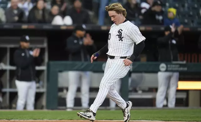 Chicago White Sox's Chase Meidroth (21) scores on a double from Jacob Amaya during the second inning of a baseball game against the Boston Red Sox, Friday, April 11, 2025, in Chicago. (AP Photo/Erin Hooley)
