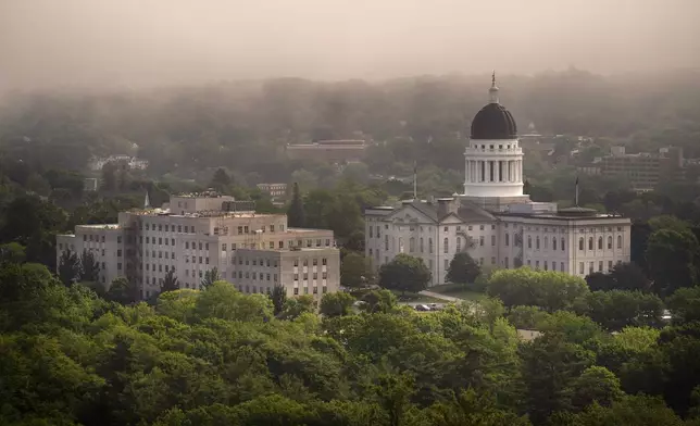 FILE-The morning fog lifts beyond the Burton M. Cross Building, left, and the State House, in this June 21, 2023, file photo, in Augusta, Maine. (AP Photo/Robert F. Bukaty, File)