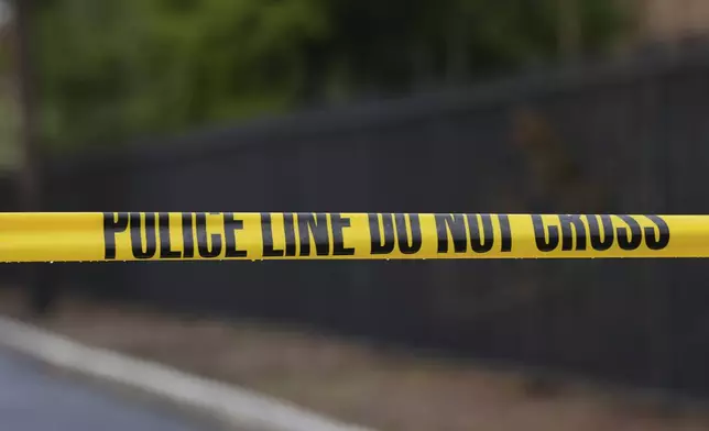 Police tape cordons off an area outside Pennsylvania governor's official residence in Harrisburg, Pa., Monday, April 14, 2025. (AP Photo/Matt Rourke)