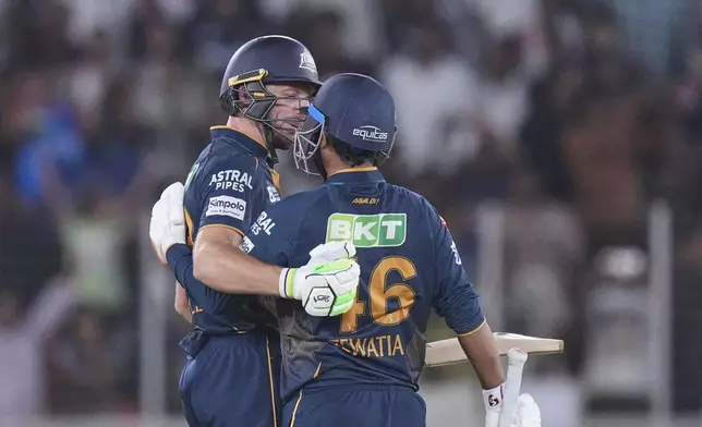 Gujarat Titans' Rahul Tewatia with batting partner Jos Butler celebrates after wining against Delhi Capitals during the Indian Premier League cricket match at Narendra Modi Stadium in Ahmedabad, India, Saturday, April 19, 2025. (AP Photo/Ajit Solanki)