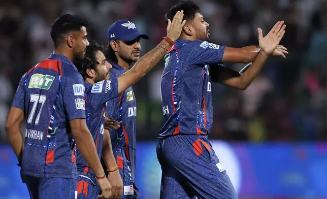 Lucknow Super Giants' Avesh Khan, right, calls for a physio after hurting his hand fielding on the last ball of the Indian Premier League cricket match between Lucknow Super Giants and Rajasthan Royals at Sawai Mansingh Stadium in Jaipur, India, Sunday, April 20, 2025. (AP Photo/Surjeet Yadav)
