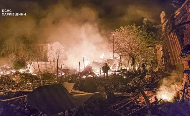 In this photo provided by the Ukrainian Emergency Service, firefighters put out a fire following a Russian drone attack that hit apartment buildings in Kharkiv, Ukraine, Wednesday, April 30, 2025. (Ukrainian Emergency Service via AP)