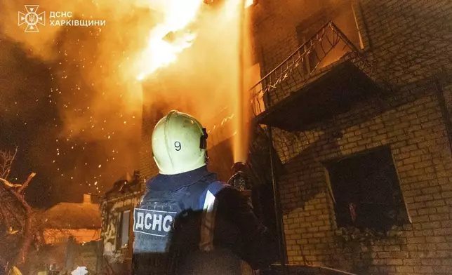 In this photo provided by the Ukrainian Emergency Service, emergency services personnel work to extinguish a fire following a Russian attack in Kharkiv, Ukraine, Wednesday, April 30, 2025. (Ukrainian Emergency Service via AP)