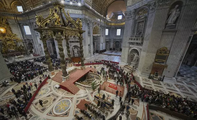 Faithful pay their respects to Pope Francis lying in state inside St. Peter's Basilica at the Vatican, Thursday, April 24, 2025. (AP Photo/Alessandra Tarantino)