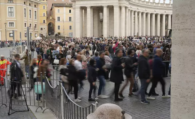 Faithful at St. Peter's Square at the Vatican, Wednesday, April 23, 2025 as the body of the late Pope Francis will lie in state inside St. Peter's Basilica for three days. (AP Photo/Markus Schreiber)