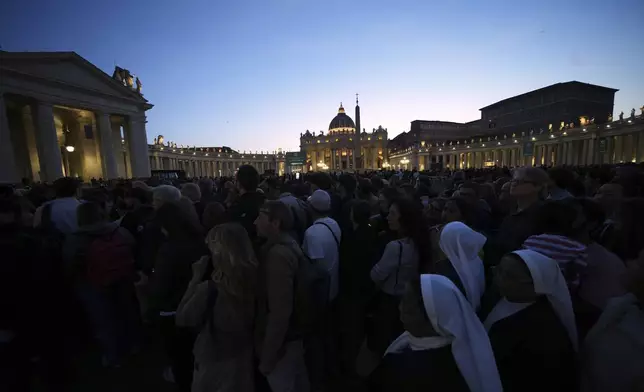 Faithful gather in St. Peter's Square at the Vatican, Wednesday, April 23, 2025 as the body of the late Pope Francis will lie in state inside St. Peter's Basilica for three days. (AP Photo/Alessandra Tarantino)