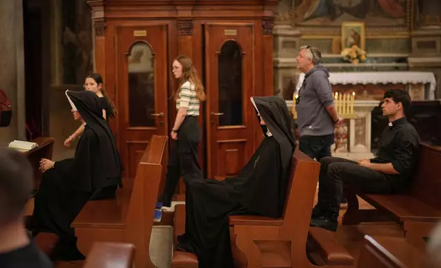 Nuns sit in the Chiesa di Santo Spirito in Sassia, outside Vatican City, Wednesday, April 23, 2025. (AP Photo/Andreea Alexandru)